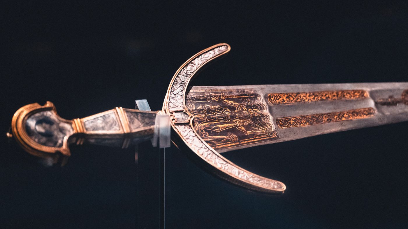 An intricately worked historical sword, illustrating the blades that define the Iron Throne.
