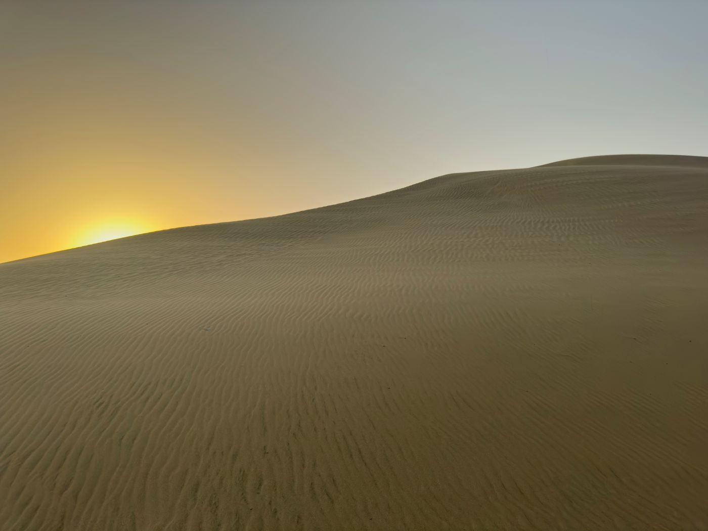 Softly lit sand dunes, illustrating a journey away from Dorne.
