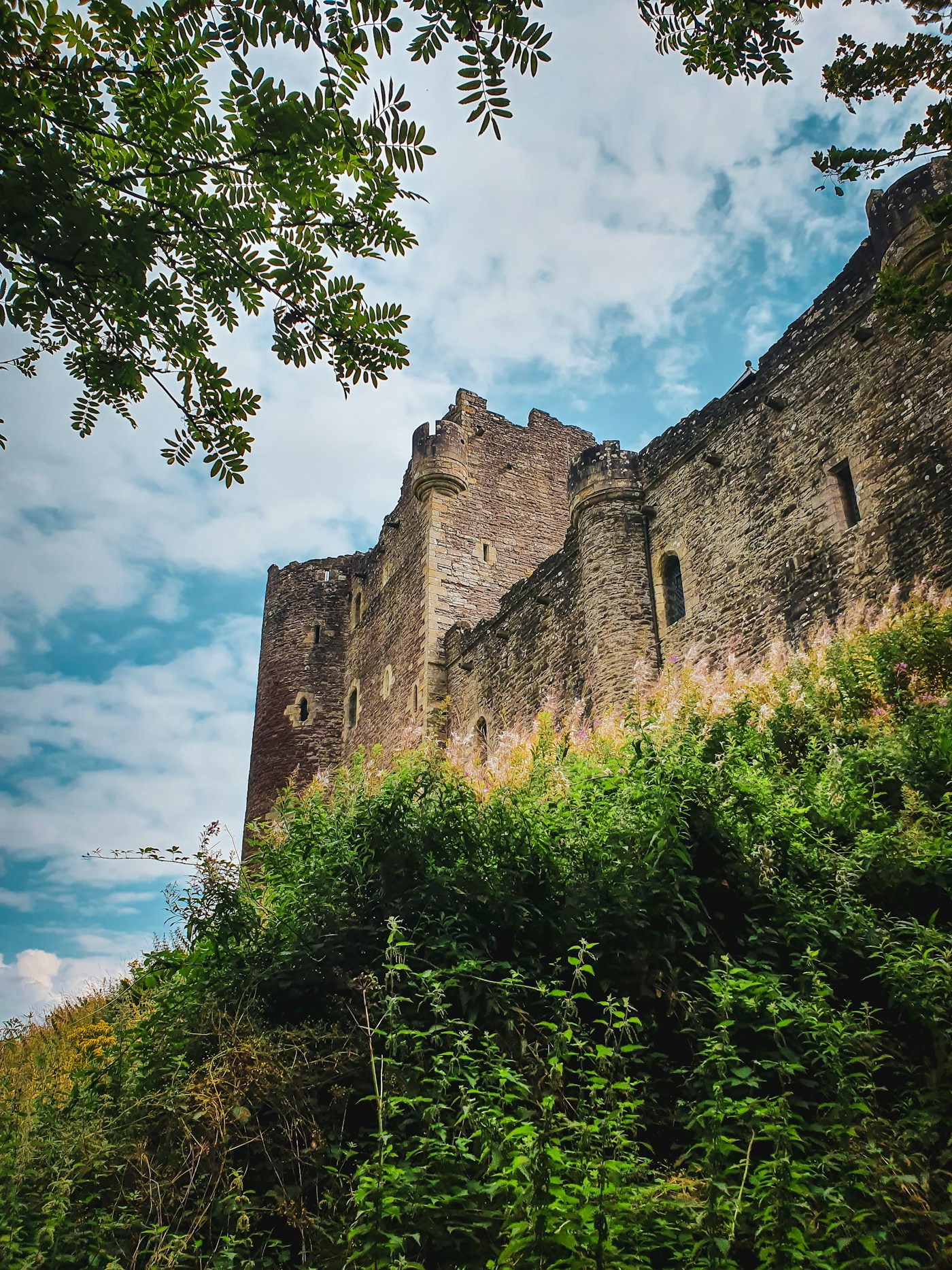 Doune Castle above a grassy hillside in Scotland