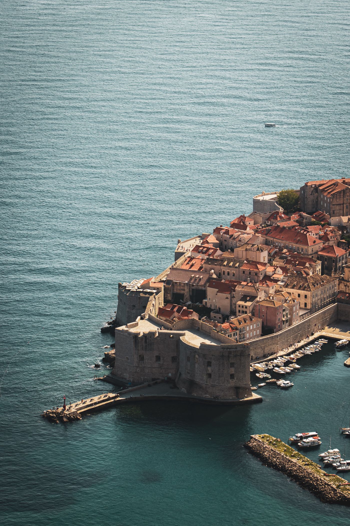 The coastal walls and red rooftops of Dubrovnik’s old town beside the Adriatic.