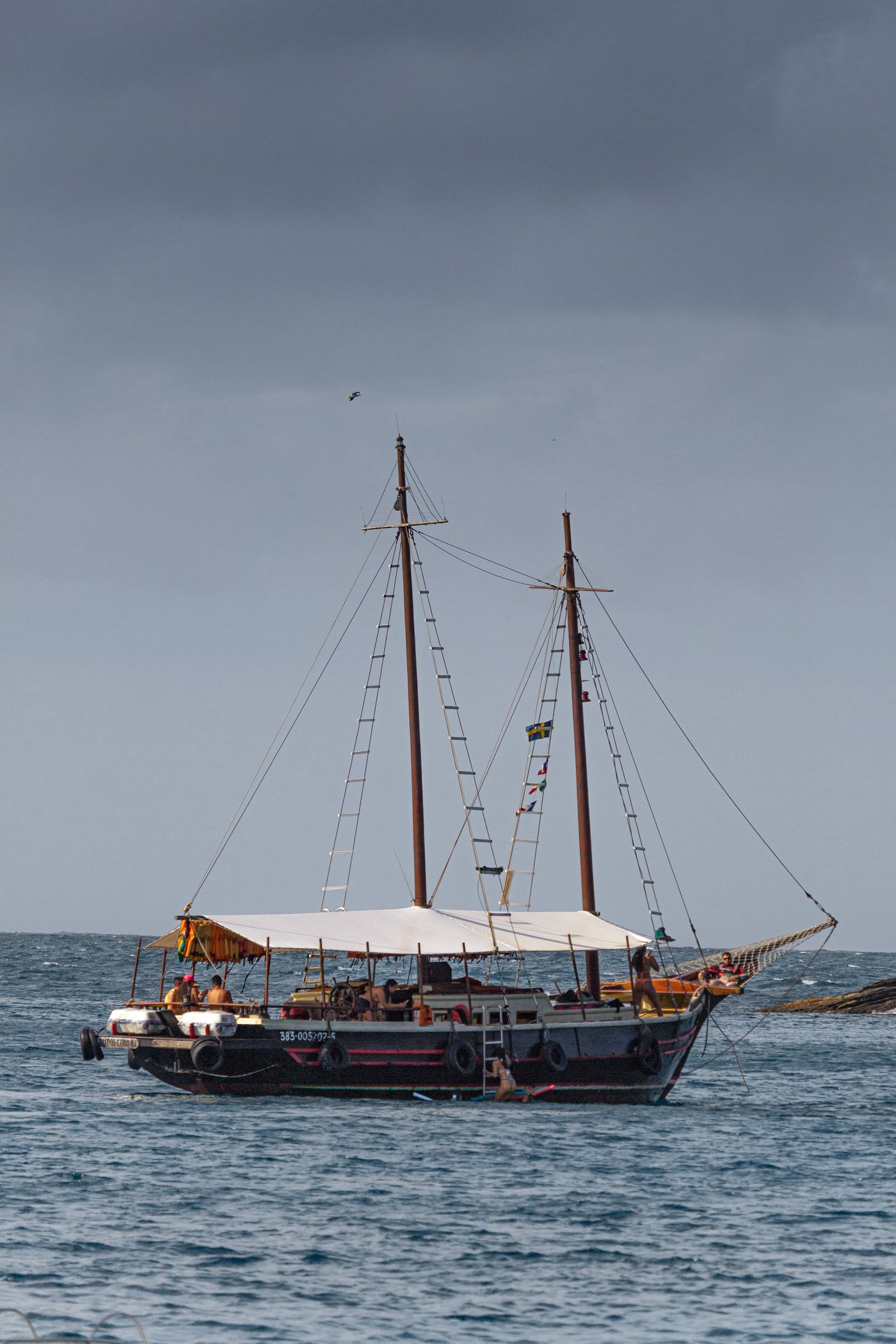 A traditional wooden vessel under grey skies, illustrating Theon’s journeys between homes.