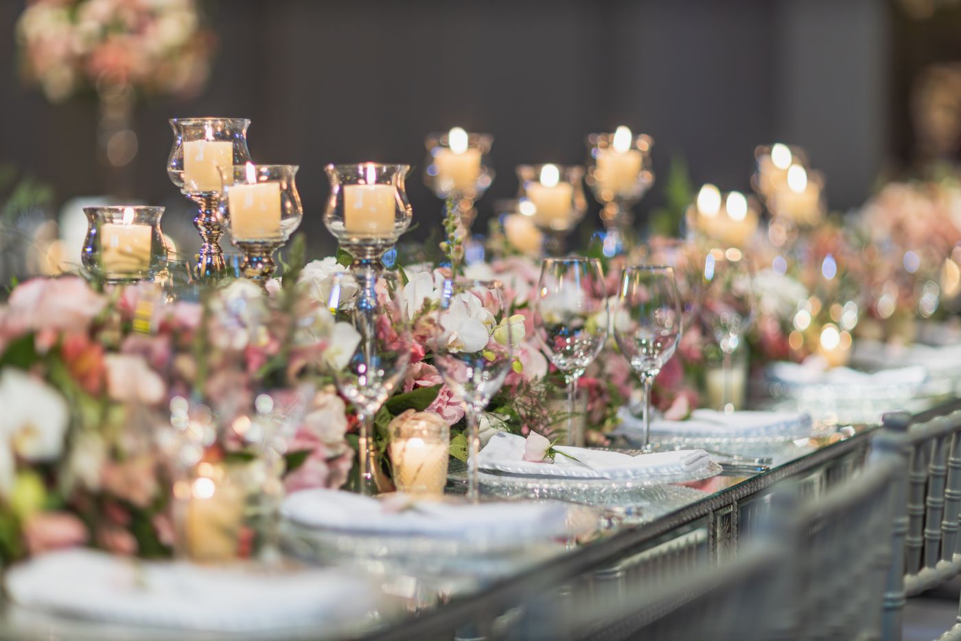 Candles and flowers on a wedding table, illustrating the ceremony behind a political alliance.